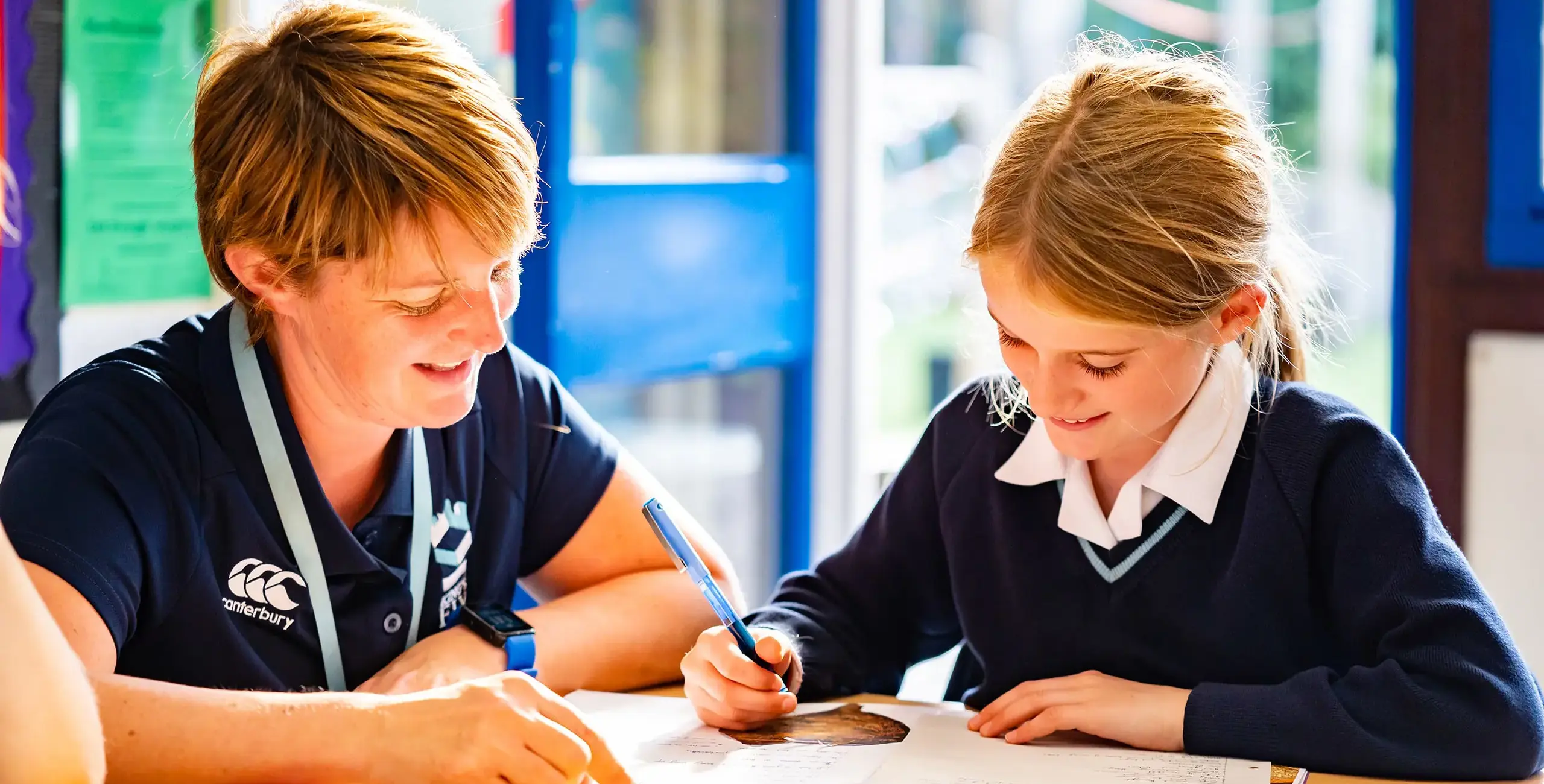 King’s Ely Prep teacher helping a student with their work.